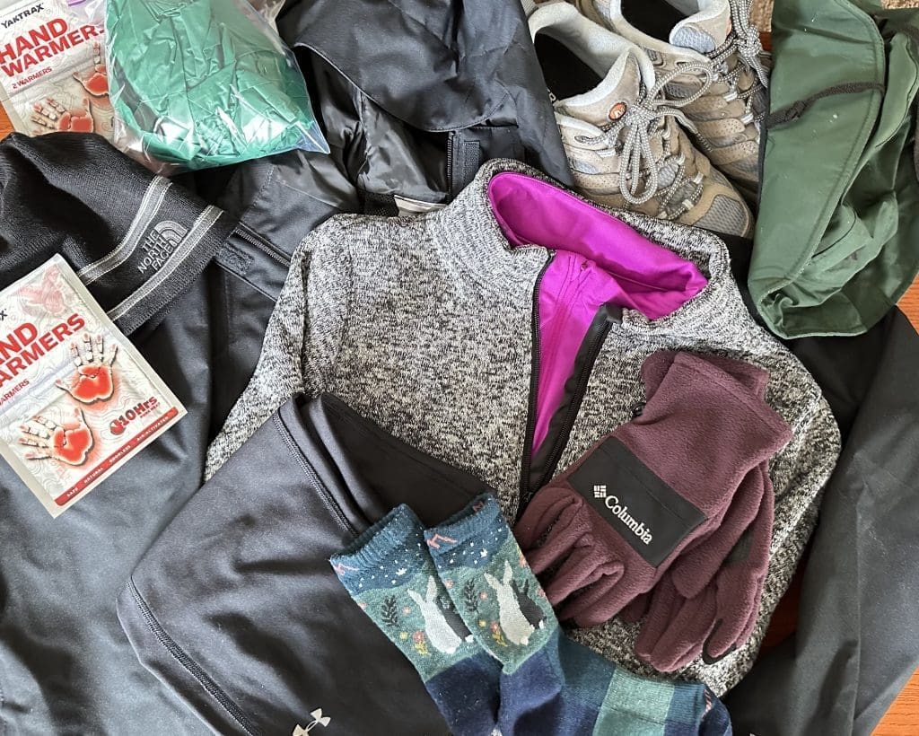 Warm clothing, hand warmers, gloves provide warmth 