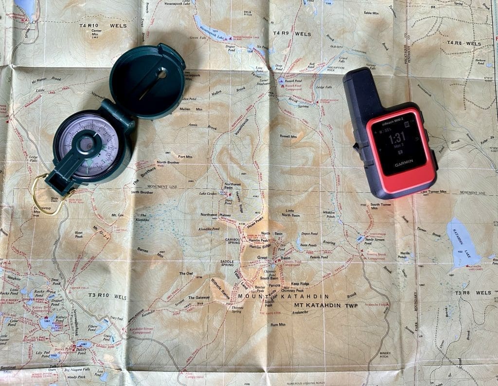 Map, compass, and Garmin Inreach Mini 2 GPS for hiking