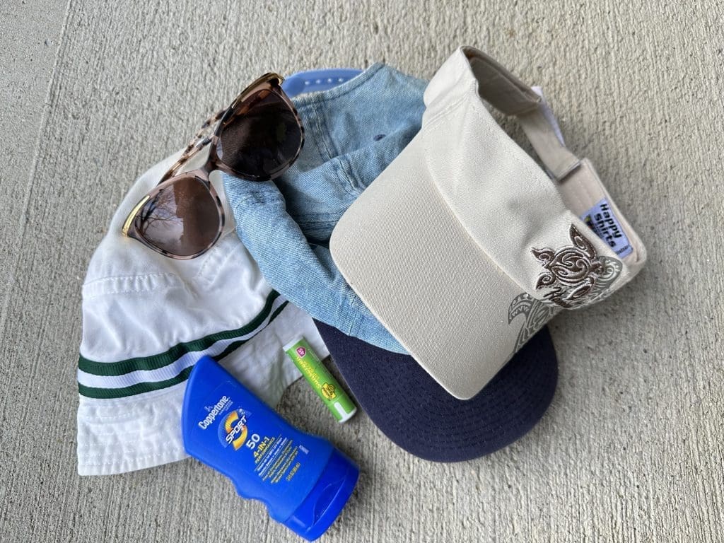 Sunscreen, lip balm, and a hat for hiking
