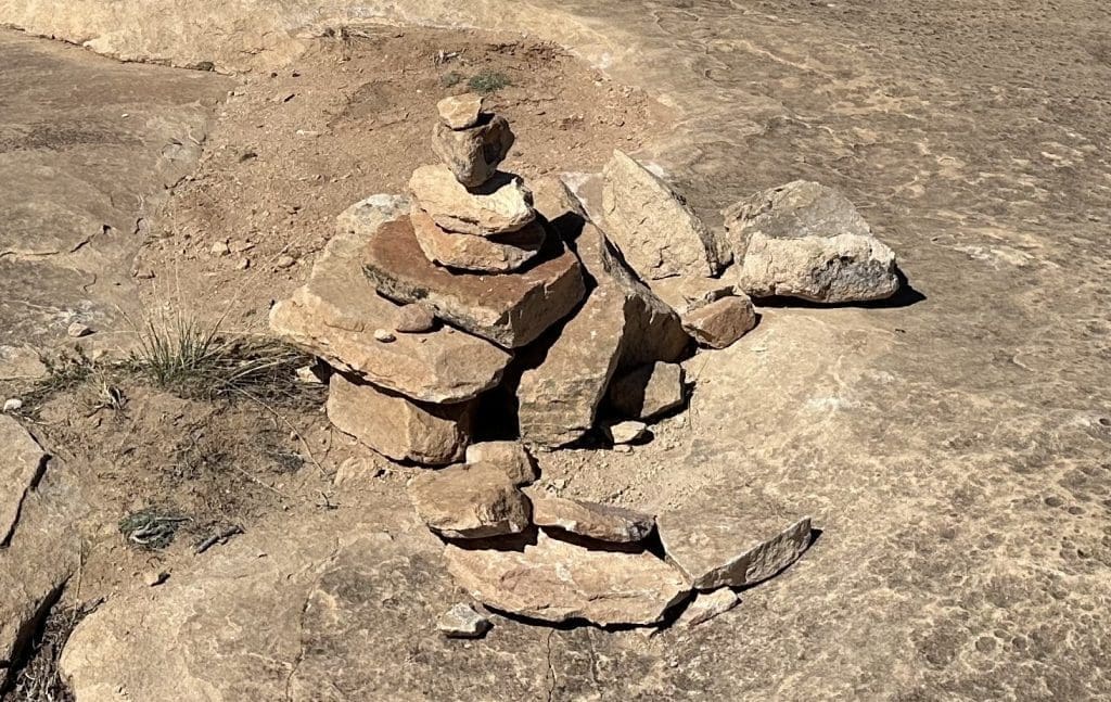 Cairns, human-made rock stacks, lead the way