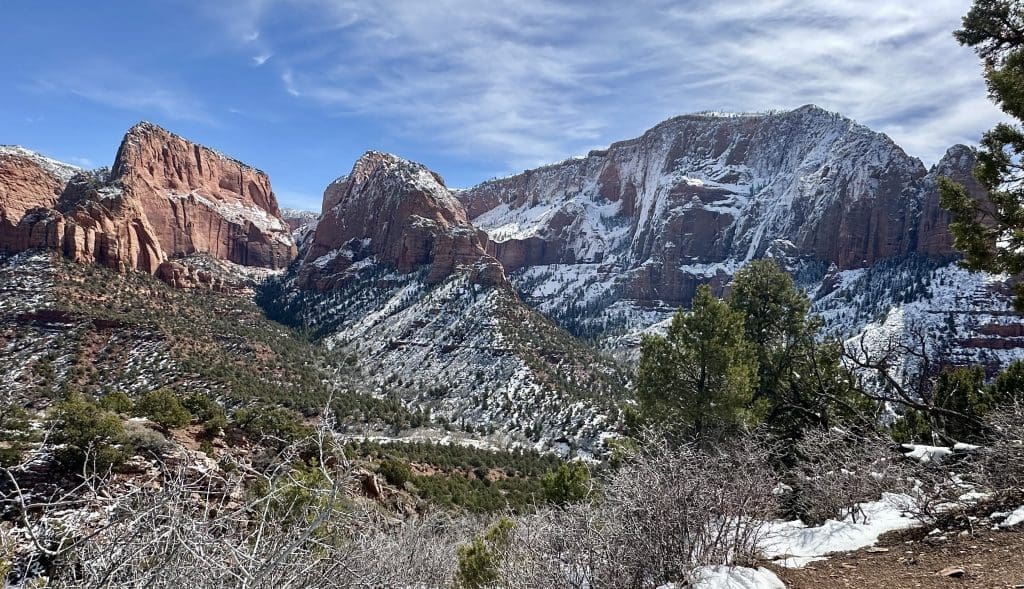 A towering rocky cliff under a clear blue sky.