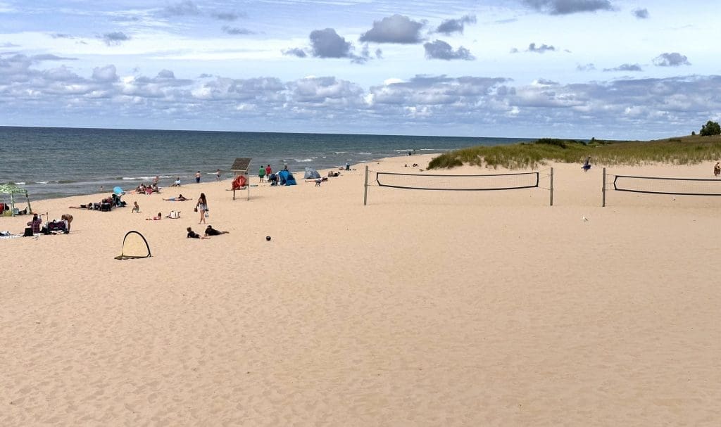 Linger at the beach near the Lake Michigan Beach House, at Ludington State Park, until late into the day