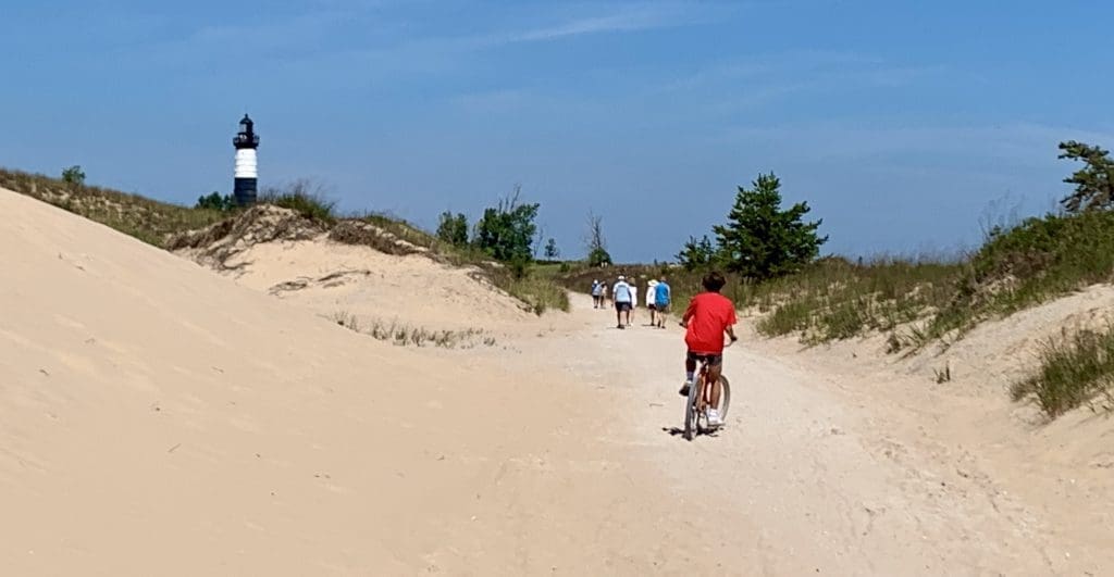 Bike or walk along the Big Sable Lighthouse Trail through the dunes