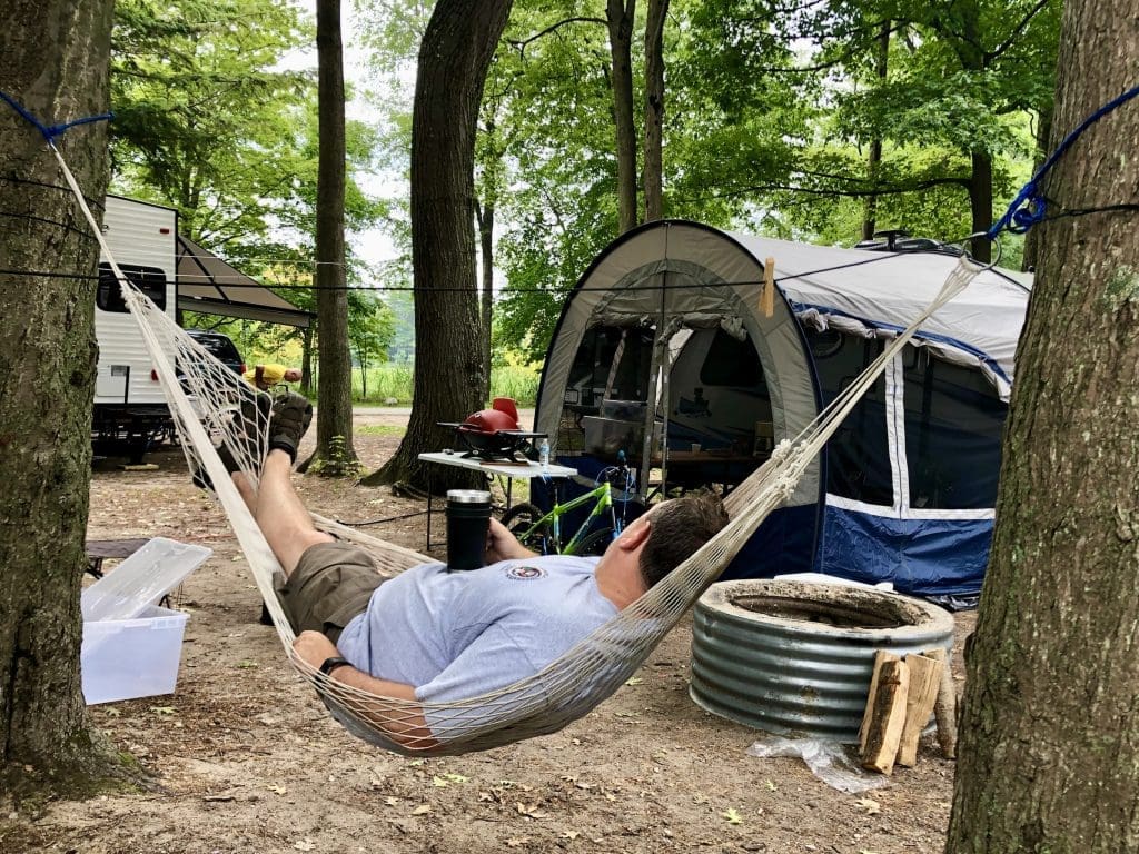Relaxing on hammock at a Beechwood Campground site is a great way to wind down the day