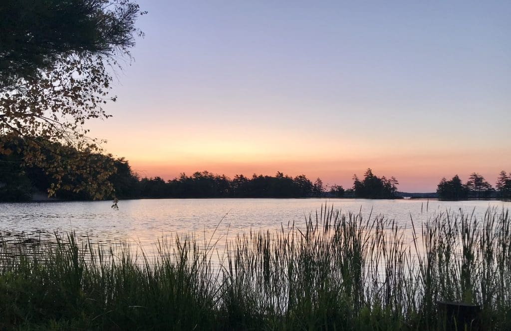 Watch the sunrise over Lost Lake on the Lost Lake Trail in Ludington State Park